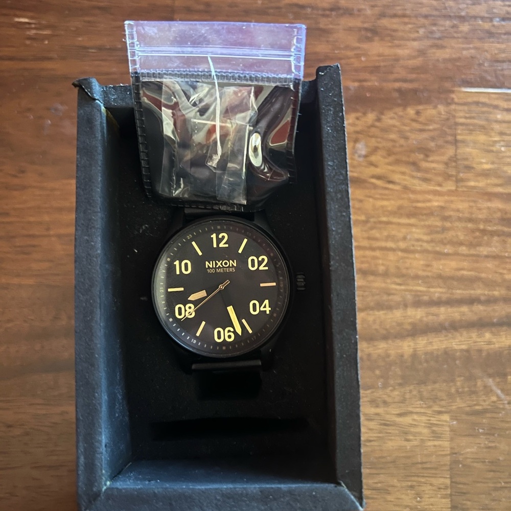 Nixon Black and Gold Dial Watch